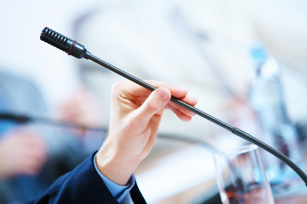 before a conference, the microphones in front of empty chairs.-1